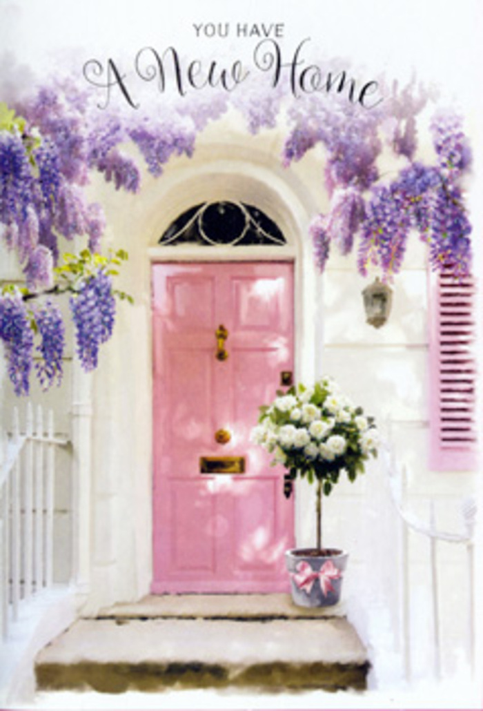 In this tranquil Wapping doorway, the scene feels like a still from a gentle love story about starting over. A softly painted pink door stands at the centre, its pastel hue warm yet understated, set into whitewashed walls that catch the light with a calm, chalky glow. To one side, a matching shutter is tinted in the same blush note, tying the façade together with an easy, thoughtful charm that feels right at home in the historic lanes near the river. Overhead, wisteria drapes in full, fragrant cascades of lavender and lilac, its trailing racemes hanging down in loose layers and brushing the top of the doorframe. The greenery is lush but not overpowering, framing the entrance like a natural garland that could have crept along a brick wall backing onto Wapping Woods. On the stone step, placed with deliberation, sits a simple grey tin bucket transformed into an elegant vessel. It is filled to overflowing with creamy white roses, their layered petals plush and cloudlike, some blooms turned just enough that you can almost imagine the texture beneath your fingertips. Between them, soft green foliage peeks out, giving the composition depth and a hint of wildness, as though the florist has mixed cultivated roses with freshly snipped garden stems. A pink ribbon is tied snugly around the base of the bucket, its satin tails resting lightly against the step, mirroring the shade of the door and adding a final, affectionate flourish. The overall mood is one of quiet joy and gentle anticipation, the sort of floral welcome that might be waiting outside a newly purchased flat close to St Katharine Docks or a restored warehouse home, ready to greet its owners with a message of comfort, hope, and lasting belonging.